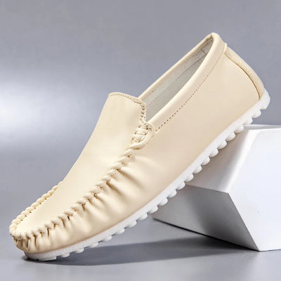 Beige loafer shoe on a gray background