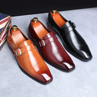 Three men's dress shoes in brown, red, and black on a light gray surface.