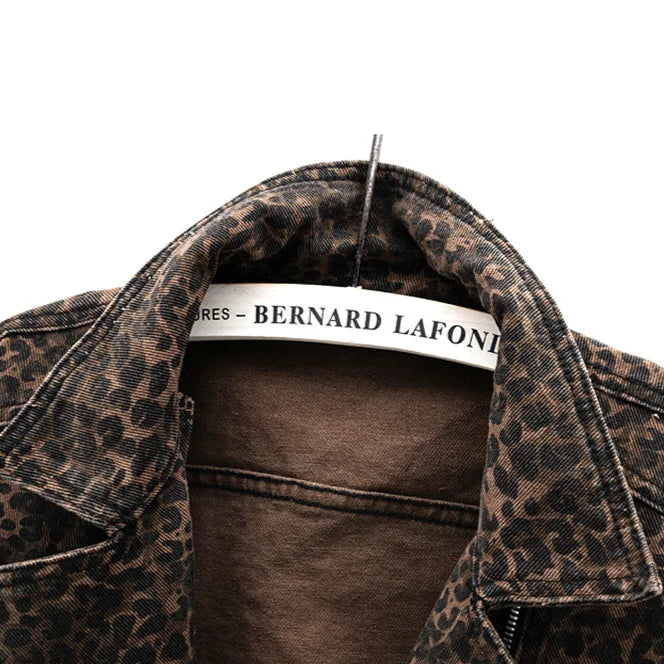 Close-up of turn-down collar and neckline on leopard print denim jacket.